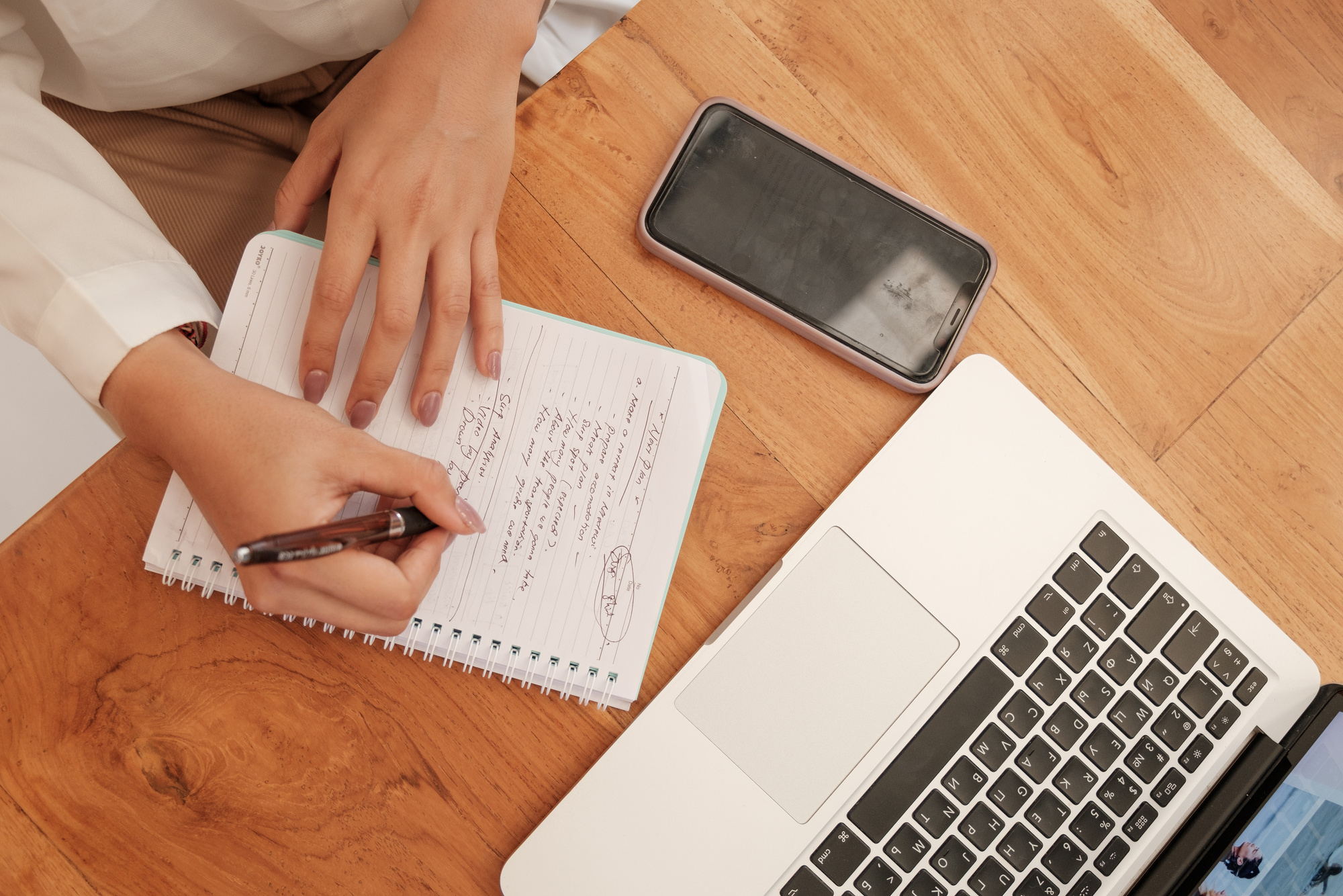 Woman Writing on Notebook